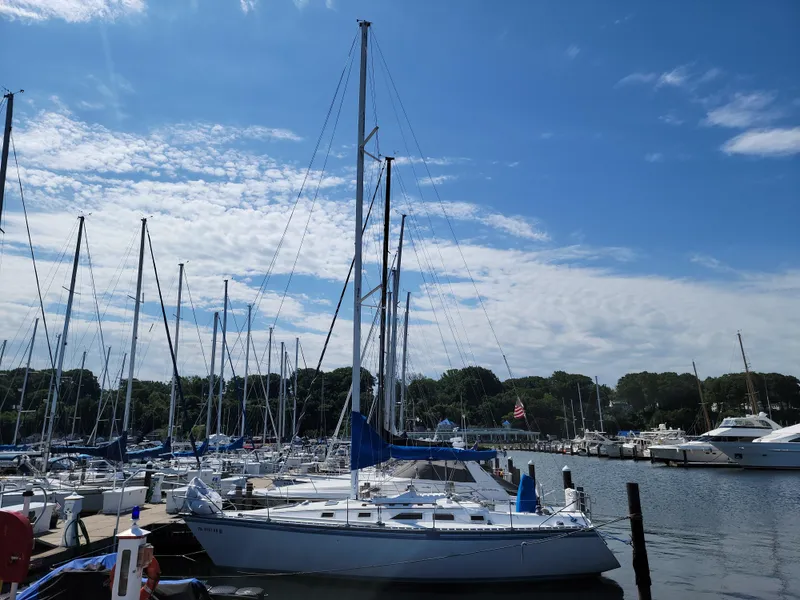 Slide: The Image of 1984 Hunter 34 sailboat docked at a marina on a sunny day. - 3