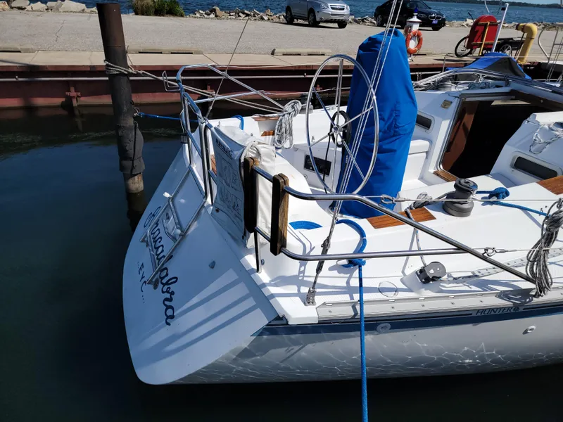 Slide: The Image of 1984 Hunter 34 sailboat docked at marina, sunny day, calm water. - 31