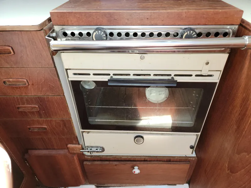 Slide: The Image of Vintage 1984 Hunter 34 sailboat kitchen with wood cabinetry and built-in oven. - 38