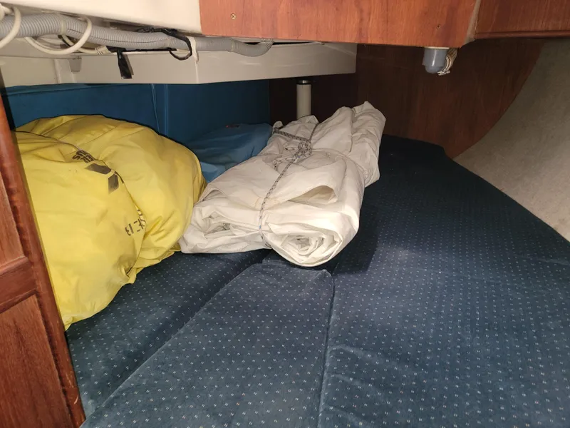 Slide: The Image of Interior cabin of 1984 Hunter 34 sailboat with stored sails and cushions. - 42