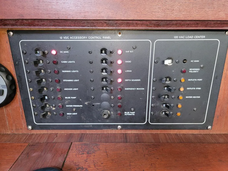 Slide: The Image of Control panel of a 1984 Hunter 34 sailboat with various switches and indicators. - 47