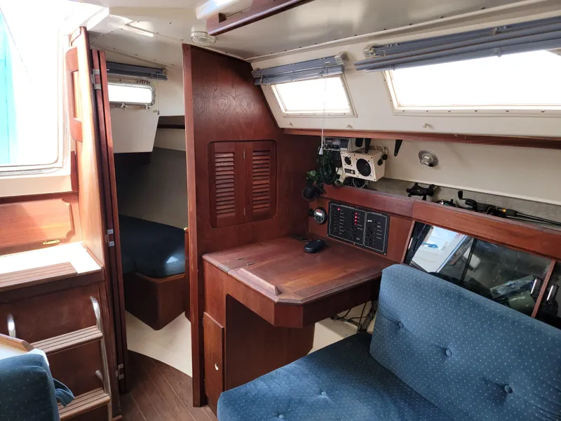 Slide: The Image of Interior of 1984 Hunter 34 sailboat with wood paneling and blue upholstery. - 49