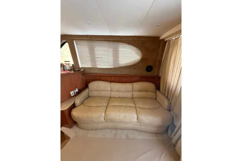 Slide: The Image of Interior of 2006 Silverton 36 Convertible with beige leather sofa and window blinds. - 10