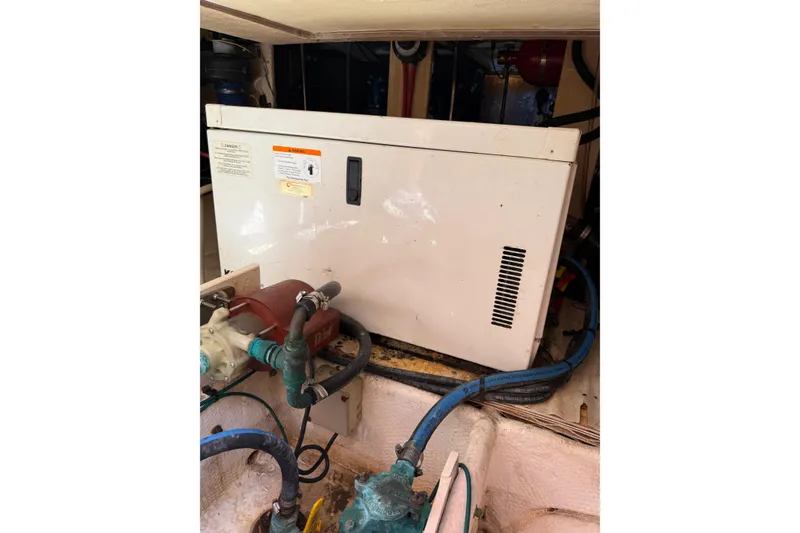 Slide: The Image of Engine room of 2006 Silverton 36 Convertible with visible machinery and hoses. - 18