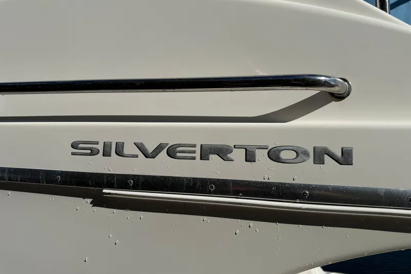 Slide: The Image of 2006 Silverton 36 Convertible boat nameplate with chrome accents and water droplets. - 19