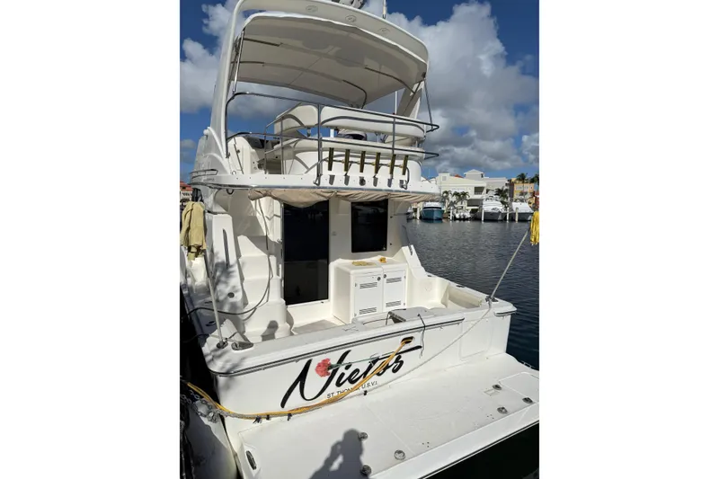 Slide: The Image of 2006 Silverton 36 Convertible yacht docked in a marina under a clear blue sky. - 20
