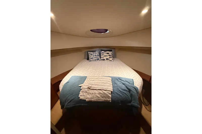 Slide: The Image of Cozy bedroom in 2006 Silverton 36 Convertible yacht with nautical-themed decor. - 4