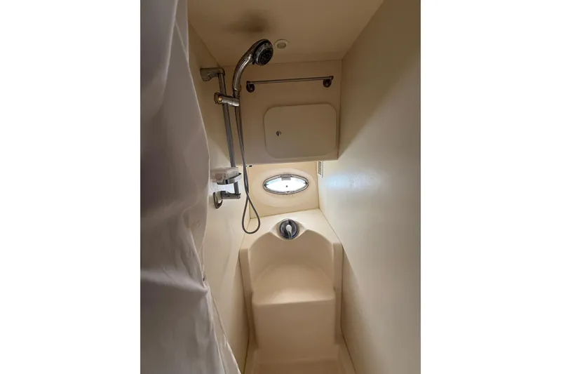 Slide: The Image of 2006 Silverton 36 Convertible yacht bathroom with shower and porthole window. - 5