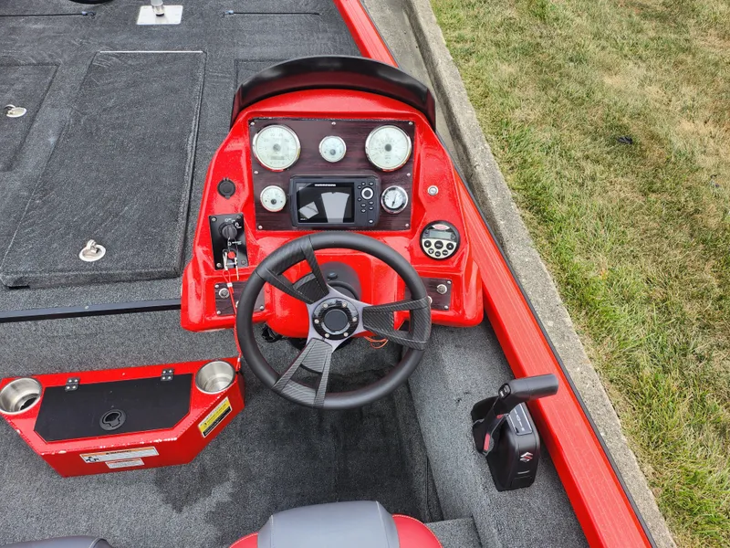 Slide: The Image of 2021 Caravelle Raptor 180 Bass boat dashboard with steering wheel and control panel. - 12