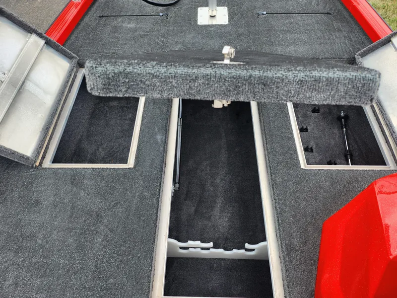 Slide: The Image of 2021 Caravelle Raptor 180 Bass boat interior with open storage compartments. - 16