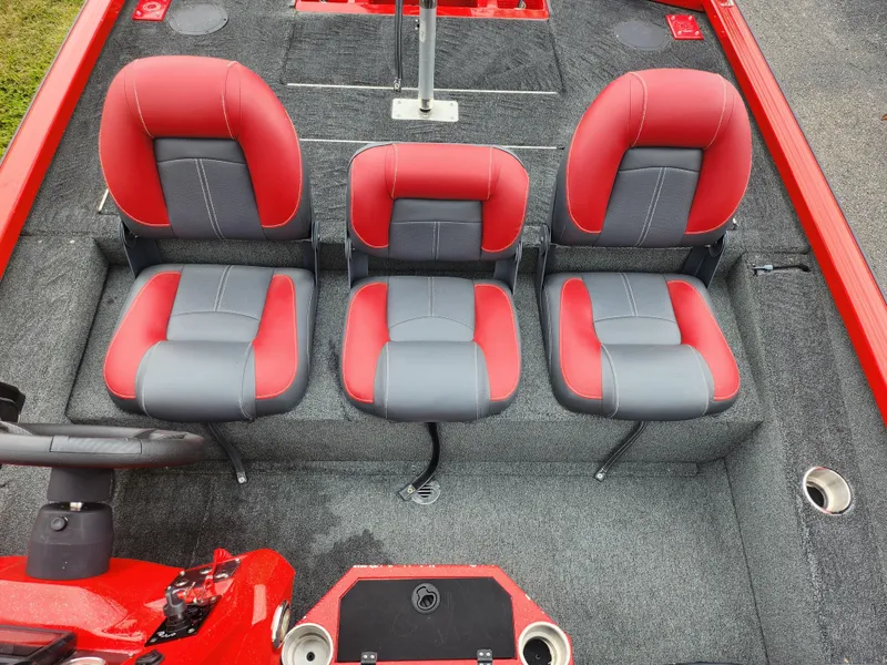 Slide: The Image of 2021 Caravelle Raptor 180 Bass boat interior with red and gray seating. - 20