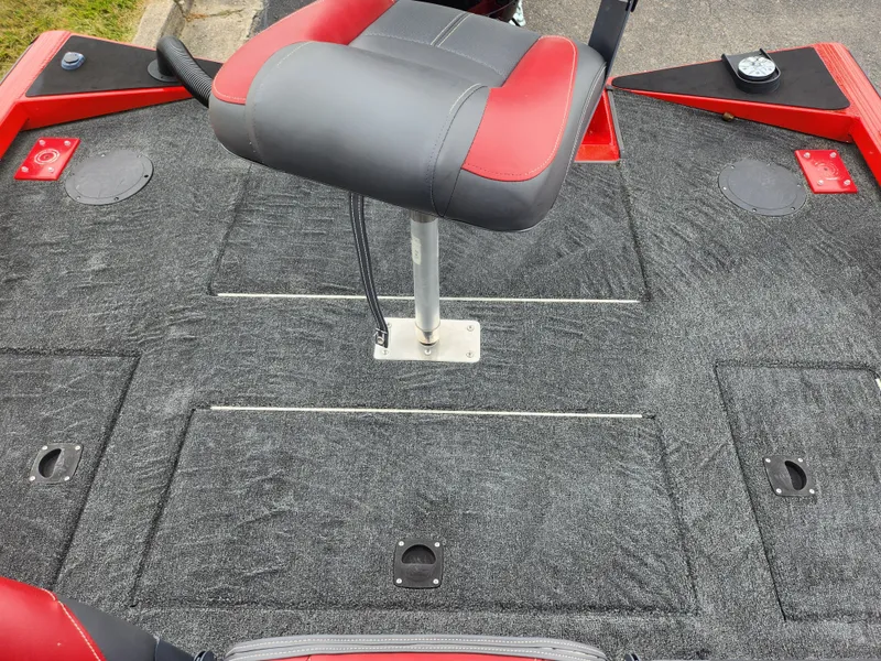 Slide: The Image of 2021 Caravelle Raptor 180 Bass boat deck with red and gray seating. - 21