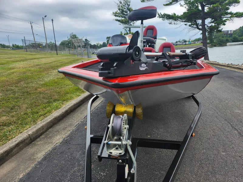 Slide: The Image of 2021 Caravelle Raptor 180 Bass boat on trailer near a lake. - 7
