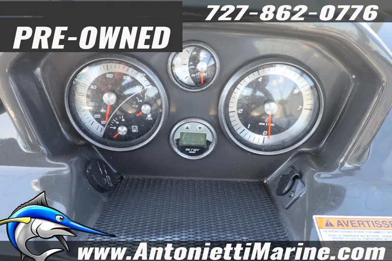 Slide: The Image of Dashboard of a 2020 Bayliner VR5 Bowrider OB, pre-owned, with gauges and contact information. - 13