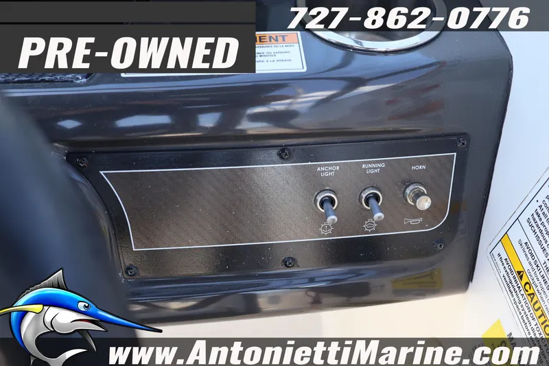Slide: The Image of Pre-owned 2020 Bayliner VR5 Bowrider OB control panel with switches and contact details. - 16