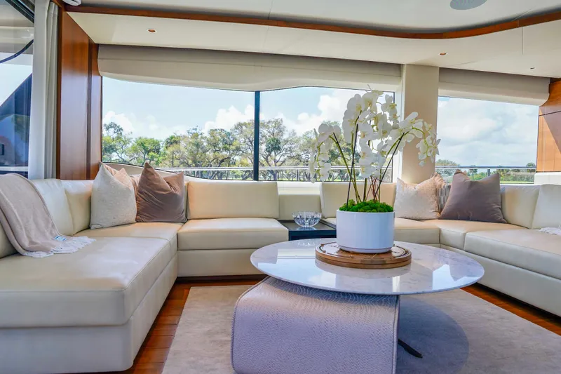 Slide: The Image of Luxurious 2021 Princess Y85 yacht interior with elegant seating and decorative orchid centerpiece. - 15