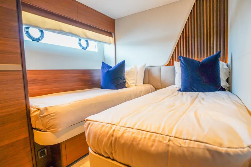 Slide: The Image of Luxurious twin cabin interior on 2021 Princess Y85 yacht with elegant wood paneling. - 26