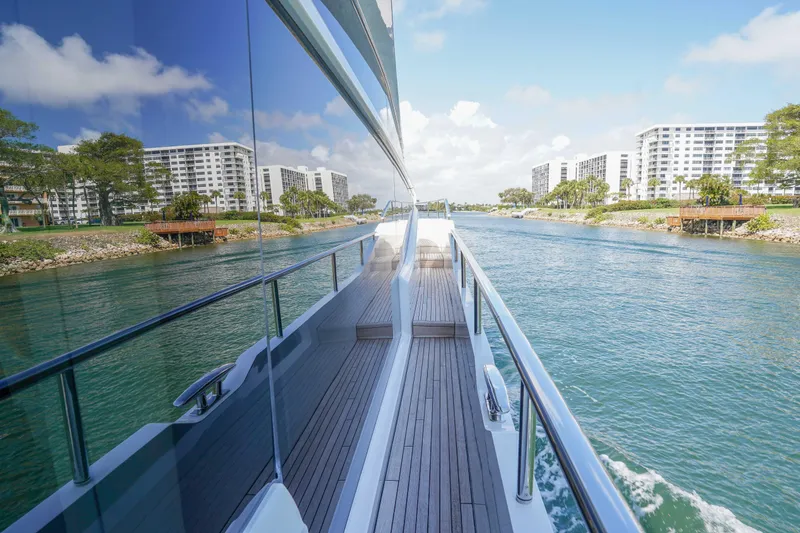 Slide: The Image of Luxury Princess Y85 yacht cruising along a scenic waterfront, 2021 model. - 8