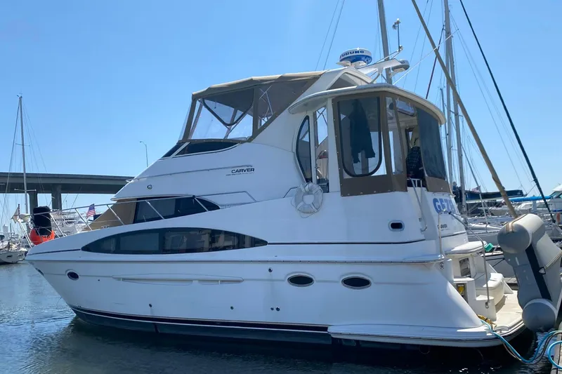 The Image of 2001 Carver 396 Motor Yacht docked in marina, side view. - 0