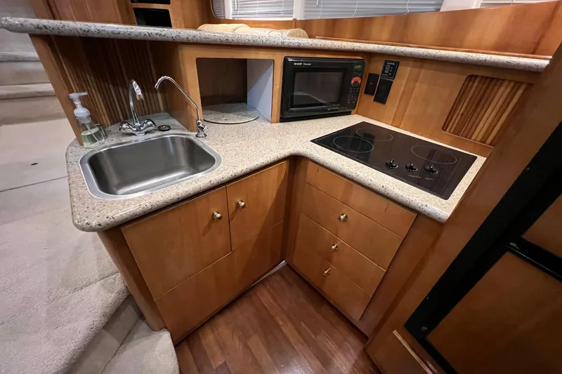 Slide: The Image of 2001 Carver 396 Motor Yacht kitchen with sink, stove, and microwave. - 11