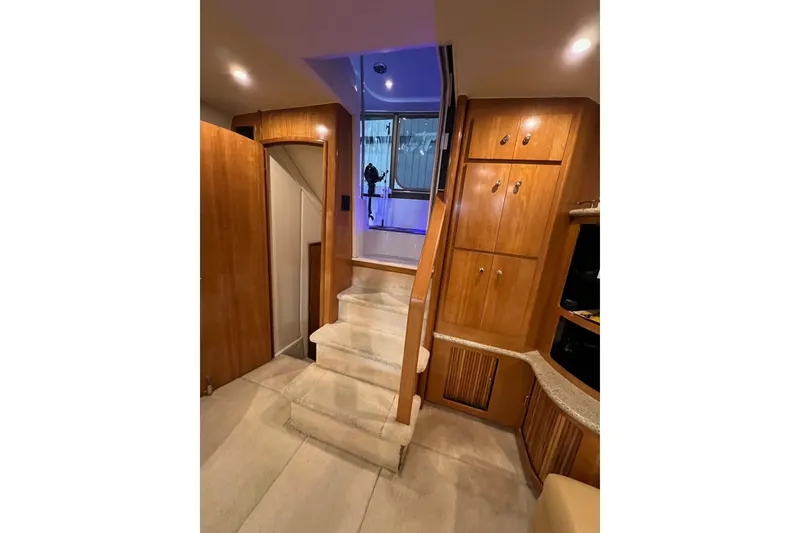 Slide: The Image of Interior of 2001 Carver 396 Motor Yacht with wooden cabinetry and carpeted stairs. - 12
