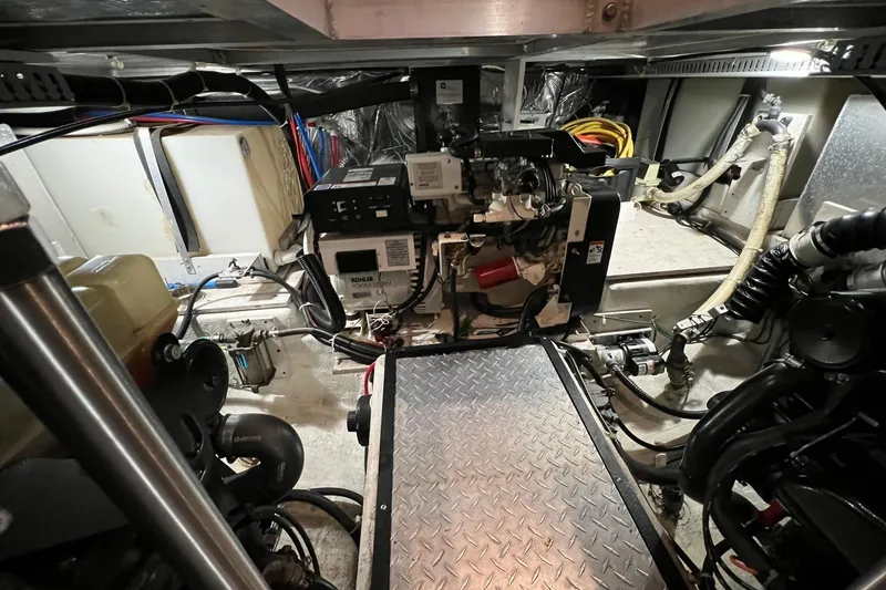 Slide: The Image of Engine room of 2001 Carver 396 Motor Yacht with visible machinery and wiring. - 14