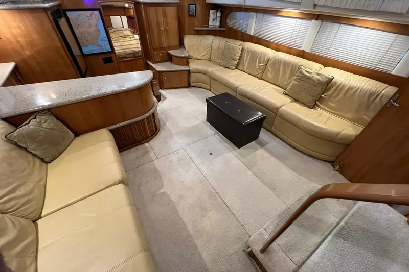 Slide: The Image of Luxurious interior of 2001 Carver 396 Motor Yacht with beige leather seating and wooden accents. - 20