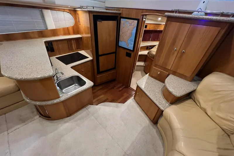 Slide: The Image of Interior of 2001 Carver 396 Motor Yacht with kitchen, seating, and wood cabinetry. - 21