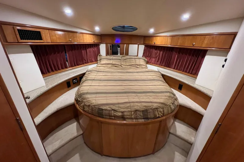 Slide: The Image of Luxurious bedroom interior of 2001 Carver 396 Motor Yacht with wood cabinetry and cozy bed. - 22