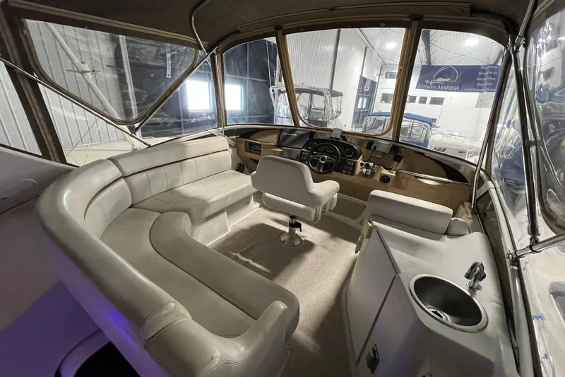 Slide: The Image of Interior of 2001 Carver 396 Motor Yacht with plush seating and helm station. - 24