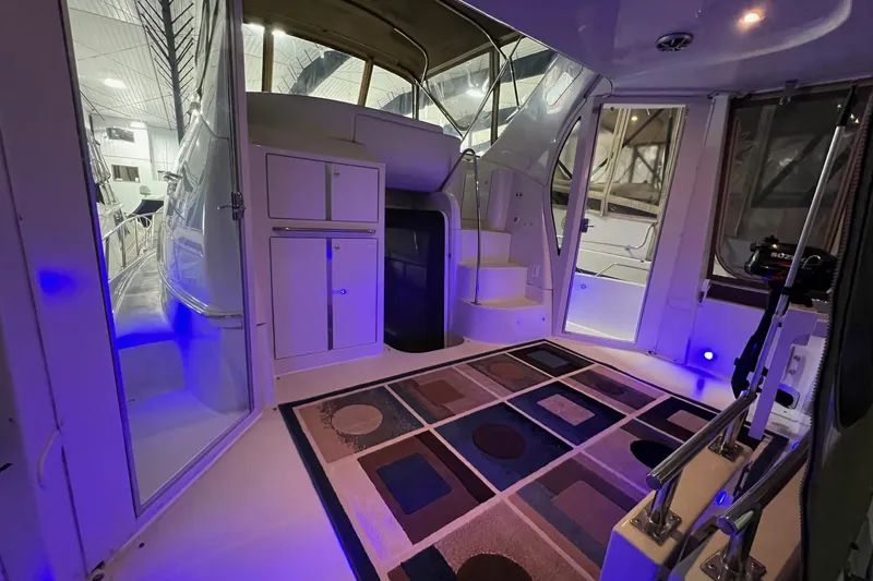 Slide: The Image of Interior of 2001 Carver 396 Motor Yacht with modern lighting and patterned rug. - 26