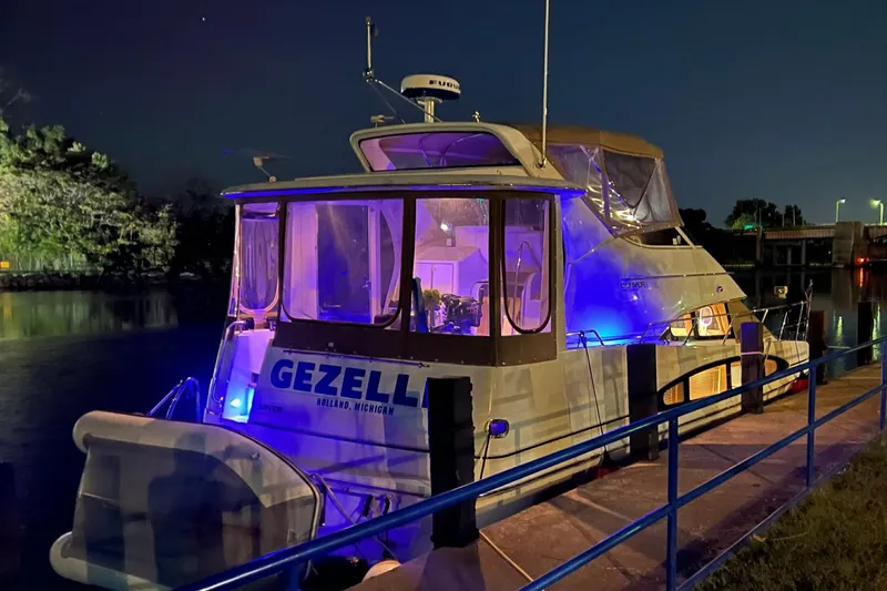 Slide: The Image of 2001 Carver 396 Motor Yacht docked at night with blue lighting. - 5