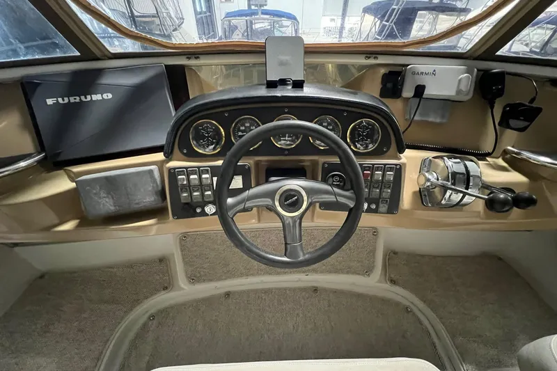 Slide: The Image of 2001 Carver 396 Motor Yacht helm with steering wheel, gauges, and navigation equipment. - 8