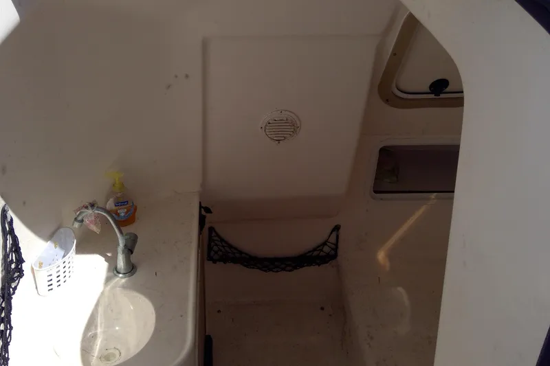 Slide: The Image of Interior of a 2004 Hurricane SunDeck 260 OB boat with sink and storage. - 13