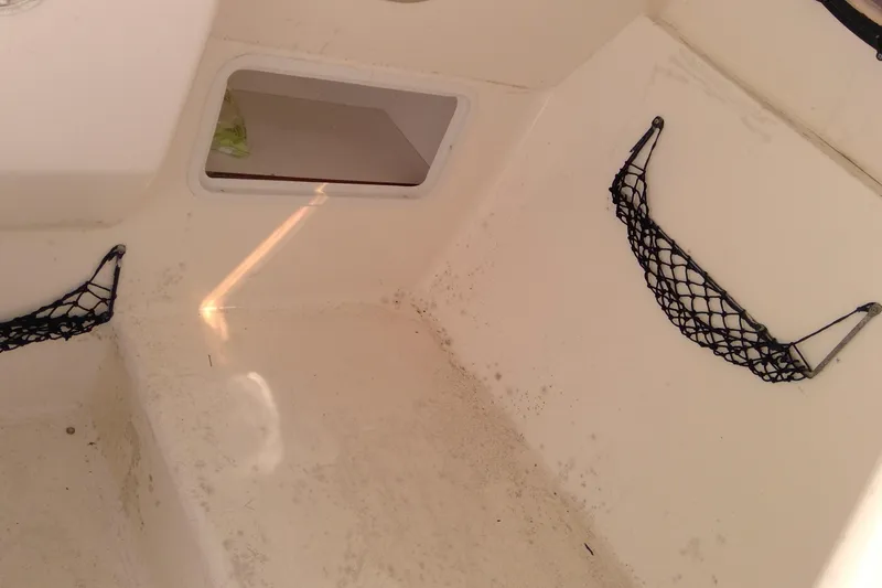 Slide: The Image of 2004 Hurricane SunDeck 260 OB interior with storage nets and compartment. - 14