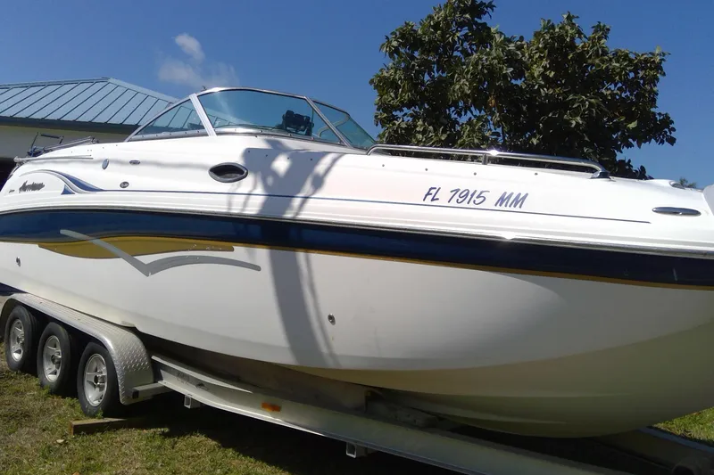 Slide: The Image of 2004 Hurricane SunDeck 260 OB boat on trailer, sunny day, blue sky background. - 6
