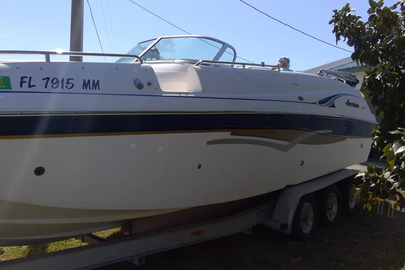 Slide: The Image of 2004 Hurricane SunDeck 260 OB boat on trailer, side view, with registration number FL 7915 MM. - 7