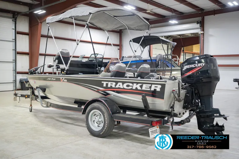 Slide: The Image of 2007 Tracker Tournament V-18 boat with Mercury engine in indoor showroom. - 10