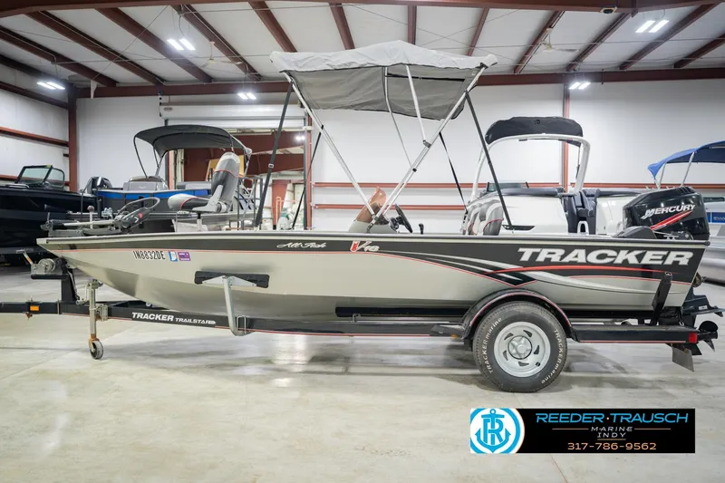 Slide: The Image of 2007 Tracker Tournament V-18 fishing boat with canopy in indoor showroom. - 11