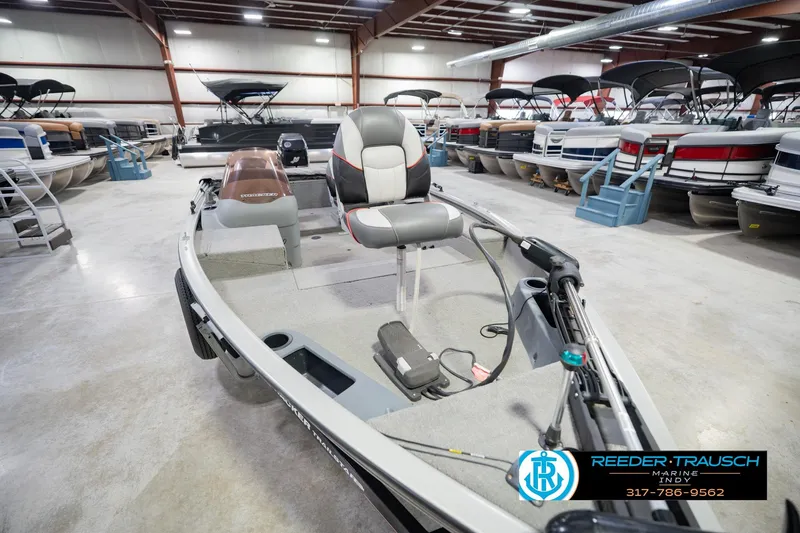 Slide: The Image of 2007 Tracker Tournament V-18 boat in showroom, surrounded by other boats. - 13