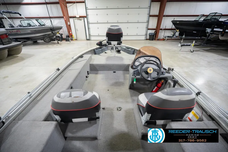 Slide: The Image of 2007 Tracker Tournament V-18 boat interior in a showroom with steering console and seating. - 16