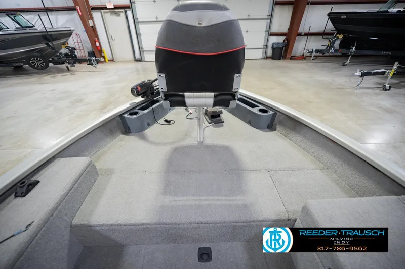 Slide: The Image of 2007 Tracker Tournament V-18 boat interior with seating and storage compartments in a showroom. - 18