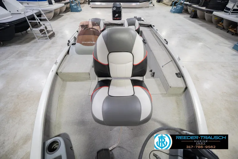 Slide: The Image of 2007 Tracker Tournament V-18 boat interior with seating and motor, displayed in showroom. - 19