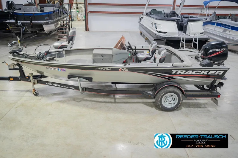 The Image of 2007 Tracker Tournament V-18 fishing boat on trailer in indoor showroom. - 2