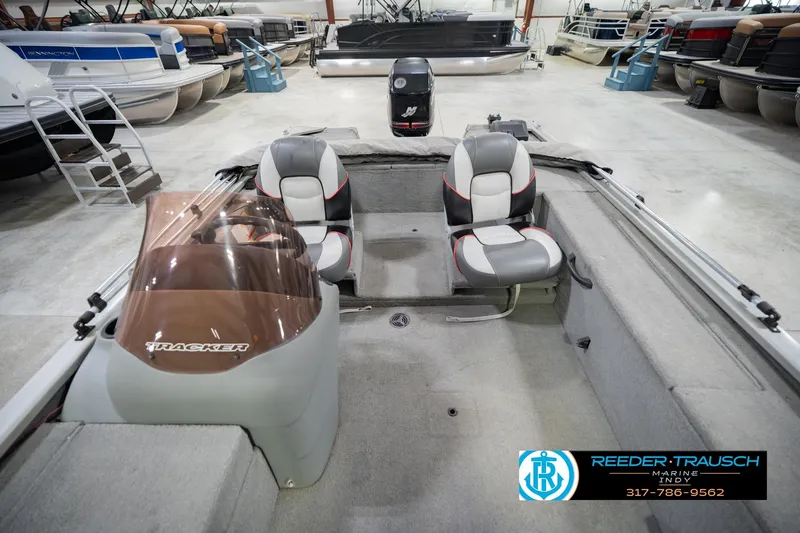Slide: The Image of 2007 Tracker Tournament V-18 boat interior with seating, displayed in a showroom. - 20
