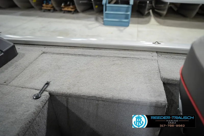 Slide: The Image of 2007 Tracker Tournament V-18 boat interior with carpeted deck and storage compartments. - 24