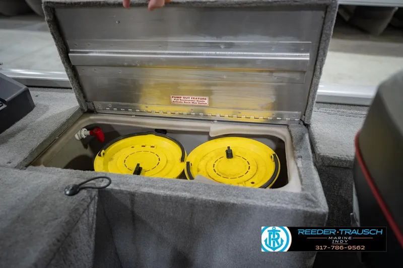 Slide: The Image of Open storage compartment in 2007 Tracker Tournament V-18 boat with yellow containers inside. - 25