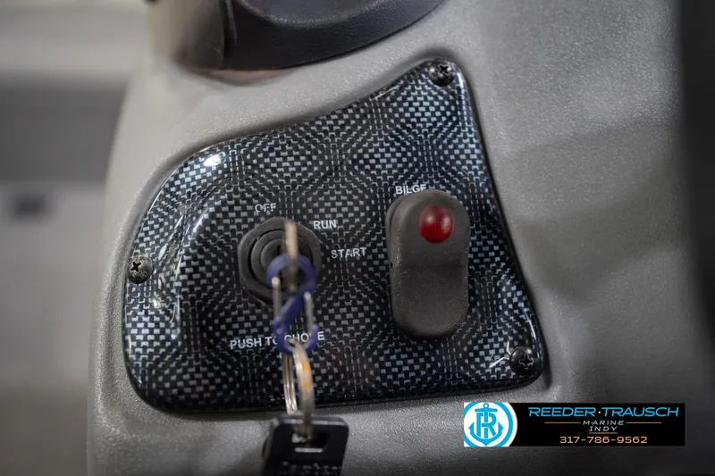 Slide: The Image of Dashboard controls of a 2007 Tracker Tournament V-18 boat with ignition switch and bilge button. - 31