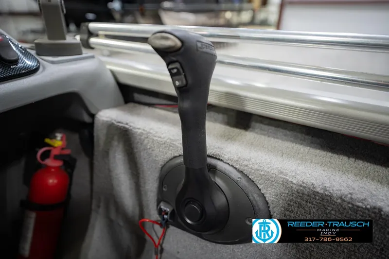 Slide: The Image of 2007 Tracker Tournament V-18 boat interior with throttle control and fire extinguisher. - 35