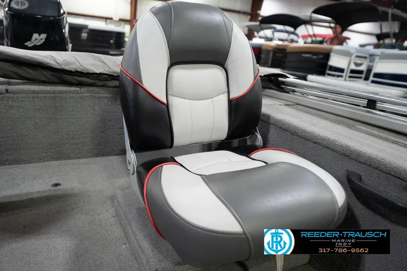 Slide: The Image of 2007 Tracker Tournament V-18 boat seat with gray, white, and red accents in showroom. - 37